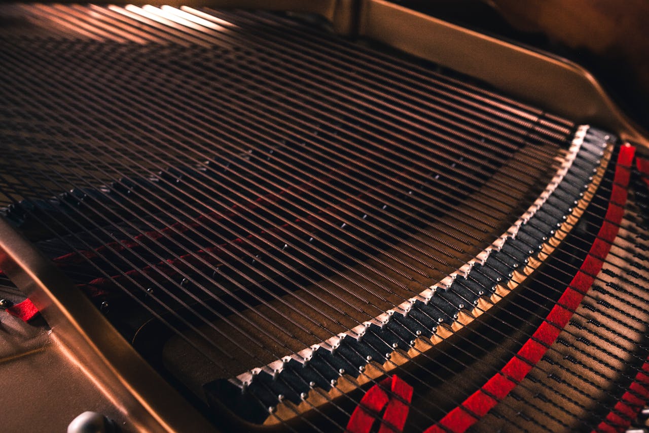 Detailed view of the strings inside a grand piano, showcasing texture and craftsmanship.
